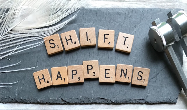 wooden blocks spelling "Shift happens"