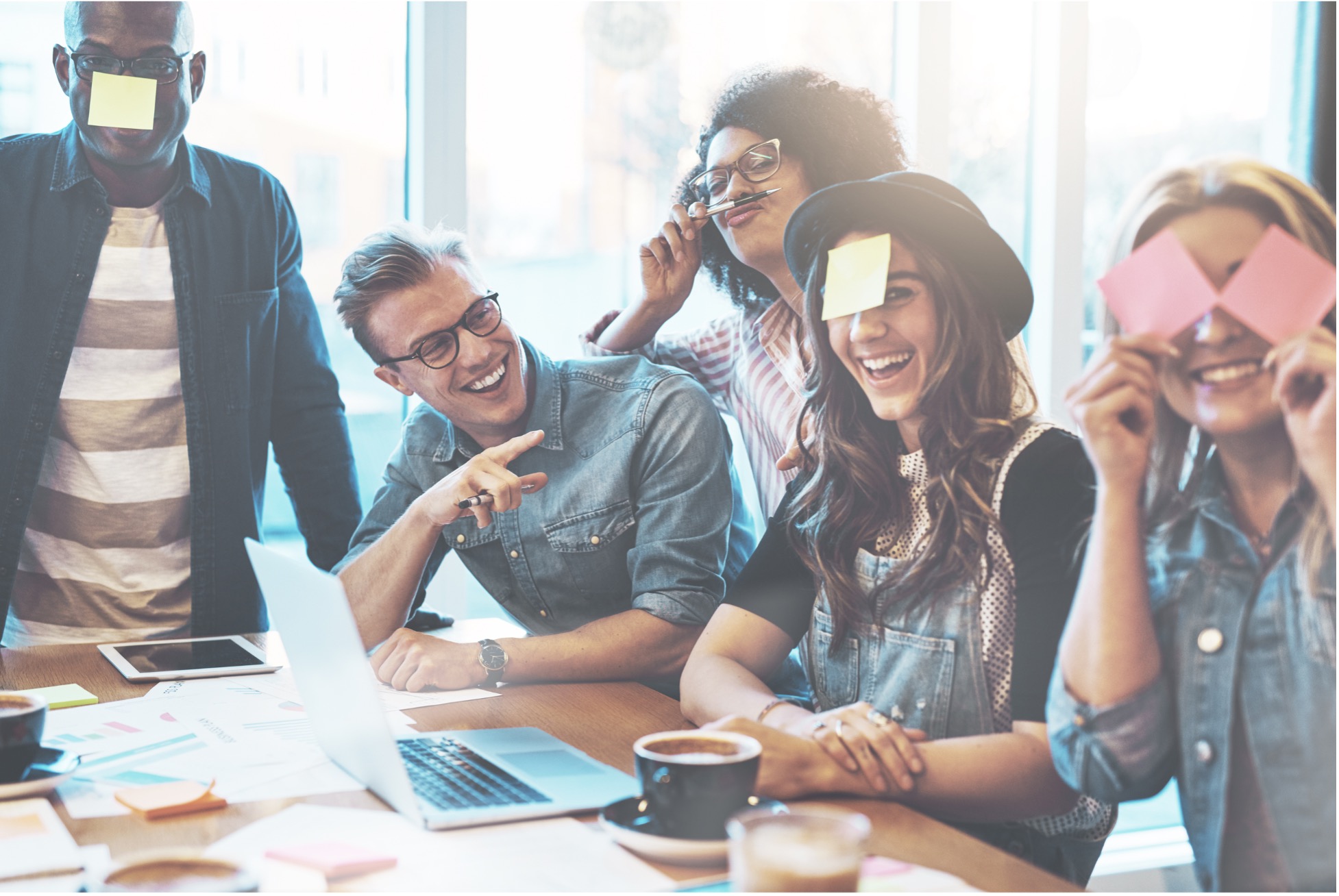 a group of people around a desk 