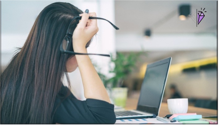 woman sitting at a desk reading